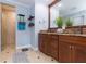 Well-lit bathroom boasts double vanity, granite countertops, wood cabinets, and a large glass-enclosed shower at 2709 Fairway View Dr, Valrico, FL 33596