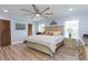 Cozy bedroom with a light wood bed frame, a striking ceiling fan, and blue wall accents at 2709 Fairway View Dr, Valrico, FL 33596