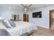 Comfortable primary bedroom boasting a large bed, TV, a dressing table and wood-look flooring at 2709 Fairway View Dr, Valrico, FL 33596