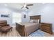 Charming bedroom featuring a ceiling fan, wooden furniture, and natural light from the window at 2709 Fairway View Dr, Valrico, FL 33596