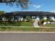 Inviting white brick house featuring a manicured lawn and lush flowerbeds at 2709 Fairway View Dr, Valrico, FL 33596