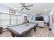 Well-lit game room features a pool table, television, and wet bar, perfect for entertaining at 2709 Fairway View Dr, Valrico, FL 33596
