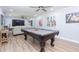 Spacious game room with a pool table, lounge area, and decorative paintings on the wall at 2709 Fairway View Dr, Valrico, FL 33596