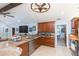 This kitchen is equipped with wood cabinets, granite countertops, stainless appliances, and bar seating at 2709 Fairway View Dr, Valrico, FL 33596