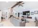 Living room featuring a stone fireplace, vaulted ceiling, comfortable seating, and stylish decor at 2709 Fairway View Dr, Valrico, FL 33596