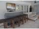 Outdoor bar area with seating on covered patio, with a nearby conversation area and light colored brick at 2709 Fairway View Dr, Valrico, FL 33596