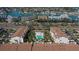 Aerial view of a townhouse community featuring a community pool and lush tropical landscaping at 325 Madeira Cir, Tierra Verde, FL 33715