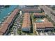 Aerial view of a waterfront townhouse community with private boat slips and lush landscaping at 325 Madeira Cir, Tierra Verde, FL 33715