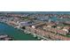 Aerial view of a waterfront community with multiple docks, boat slips, and lush landscaping at 325 Madeira Cir, Tierra Verde, FL 33715