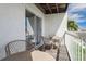 Outdoor balcony featuring patio furniture and a view of the surrounding scenery at 325 Madeira Cir, Tierra Verde, FL 33715