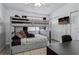 Bright bedroom features a gray bunk bed, desk and TV, as well as a closet at 325 Madeira Cir, Tierra Verde, FL 33715