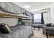 Cozy bedroom with gray bunkbeds, seating, and window that provides natural light at 325 Madeira Cir, Tierra Verde, FL 33715