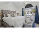 Comfortable bedroom showcasing a decorative headboard, throw pillows, and a window view at 325 Madeira Cir, Tierra Verde, FL 33715