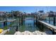 Dock with a boat lift and a boat over the water in this waterfront view at 325 Madeira Cir, Tierra Verde, FL 33715