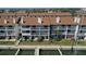 Aerial view of the exterior of townhomes with boat docks and manicured lawns at 325 Madeira Cir, Tierra Verde, FL 33715
