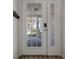 Elegant front door with glass panels, offering a view of the exterior and enhancing natural light at 325 Madeira Cir, Tierra Verde, FL 33715