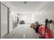 Spacious garage with seating, fishing rods, storage and gray speckled flooring at 325 Madeira Cir, Tierra Verde, FL 33715