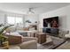 Cozy living room with a fireplace, large TV, and comfortable sectional sofa for relaxing at 325 Madeira Cir, Tierra Verde, FL 33715