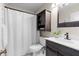 Well-lit bathroom featuring a white shower curtain, modern vanity, and dark wood cabinetry at 350 51St N Ave, St Petersburg, FL 33703