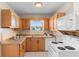 This kitchen features wooden cabinets and a white oven/microwave appliance set at 350 51St N Ave, St Petersburg, FL 33703