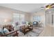 Inviting living room features neutral walls, ceiling fan, comfortable seating, and tile flooring at 350 51St N Ave, St Petersburg, FL 33703