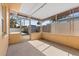 An enclosed sunroom features a screened frame with a door and durable concrete floors at 350 51St N Ave, St Petersburg, FL 33703