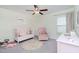 Adorable bedroom featuring a pink crib, chair, and playful decor at 3533 N Maryland Ave, Plant City, FL 33565