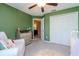 Charming bedroom featuring green accent wall, carpeted floor, and white closet doors at 3533 N Maryland Ave, Plant City, FL 33565