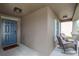 Welcoming front porch featuring a blue entry door, white shutters, and cozy rocking chairs, offering a charming entrance at 3533 N Maryland Ave, Plant City, FL 33565