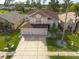 An aerial view shows a well-maintained home with a three-car garage and mature landscaping at 3633 Morgans Bluff Ct, Land O Lakes, FL 34639