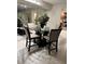 Dining area showcasing a round table with seating, a mirrored wall, and a decorative plant centerpiece at 400 Island Way # 509, Clearwater Beach, FL 33767