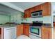 Well-lit kitchen featuring stainless steel appliances, granite countertops, and custom cabinetry at 4200 Queen N St, St Petersburg, FL 33714