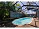 Sparkling in-ground pool surrounded by lush tropical landscaping and a screened enclosure at 4200 Queen N St, St Petersburg, FL 33714