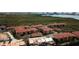 Aerial view of a well-maintained multi-Gathering residential community with red roofs and manicured landscaping at 4323 Bayside Village Dr # 204, Tampa, FL 33615