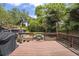 Spacious backyard deck with outdoor seating and a grill, surrounded by lush greenery at 5915 N Otis Ave, Tampa, FL 33604