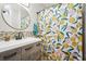 Bright bathroom featuring unique vanity, mosaic tiles, and colorful shower curtain at 5915 N Otis Ave, Tampa, FL 33604