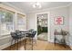 Dining room showcasing a rustic table and four chairs, with an open view to the kitchen at 5915 N Otis Ave, Tampa, FL 33604