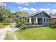 Charming blue bungalow with yellow front door and detached shed at 5915 N Otis Ave, Tampa, FL 33604
