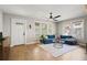 Inviting living area with a blue sectional, ceiling fan, and natural light at 5915 N Otis Ave, Tampa, FL 33604