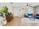 Bright living room with a blue sectional, wood floors, and modern decor at 5915 N Otis Ave, Tampa, FL 33604
