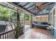 Inviting covered patio with a ceiling fan, tiled floor, and outdoor seating area at 5915 N Otis Ave, Tampa, FL 33604