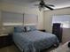 Neat bedroom with patterned blue bedspread, bedside tables, and a ceiling fan at 6322 113Th St, Seminole, FL 33772