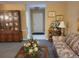 Cozy living room featuring a wood china cabinet, patterned sofa, and view of the tiled front entry at 6322 113Th St, Seminole, FL 33772