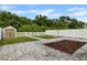 Backyard featuring a storage shed, white privacy fence and a stone paver patio at 7842 Carriage Pointe Dr, Gibsonton, FL 33534