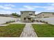 Backyard featuring a patio set with umbrella, a stone pathway and a white privacy fence at 7842 Carriage Pointe Dr, Gibsonton, FL 33534