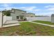 Backyard featuring a stone paver patio, white privacy fence and a grassy area at 7842 Carriage Pointe Dr, Gibsonton, FL 33534