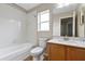 Bathroom featuring a tub with shower, toilet, vanity and tiled flooring at 7842 Carriage Pointe Dr, Gibsonton, FL 33534