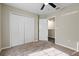 Neutral bedroom with carpet featuring double closets, bi-fold doors and an ensuite bathroom at 7842 Carriage Pointe Dr, Gibsonton, FL 33534