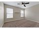 Neutral bedroom featuring a ceiling fan, carpet and two windows with blinds at 7842 Carriage Pointe Dr, Gibsonton, FL 33534