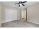 Neutral bedroom with carpet featuring double closets, bi-fold doors and an ensuite bathroom at 7842 Carriage Pointe Dr, Gibsonton, FL 33534